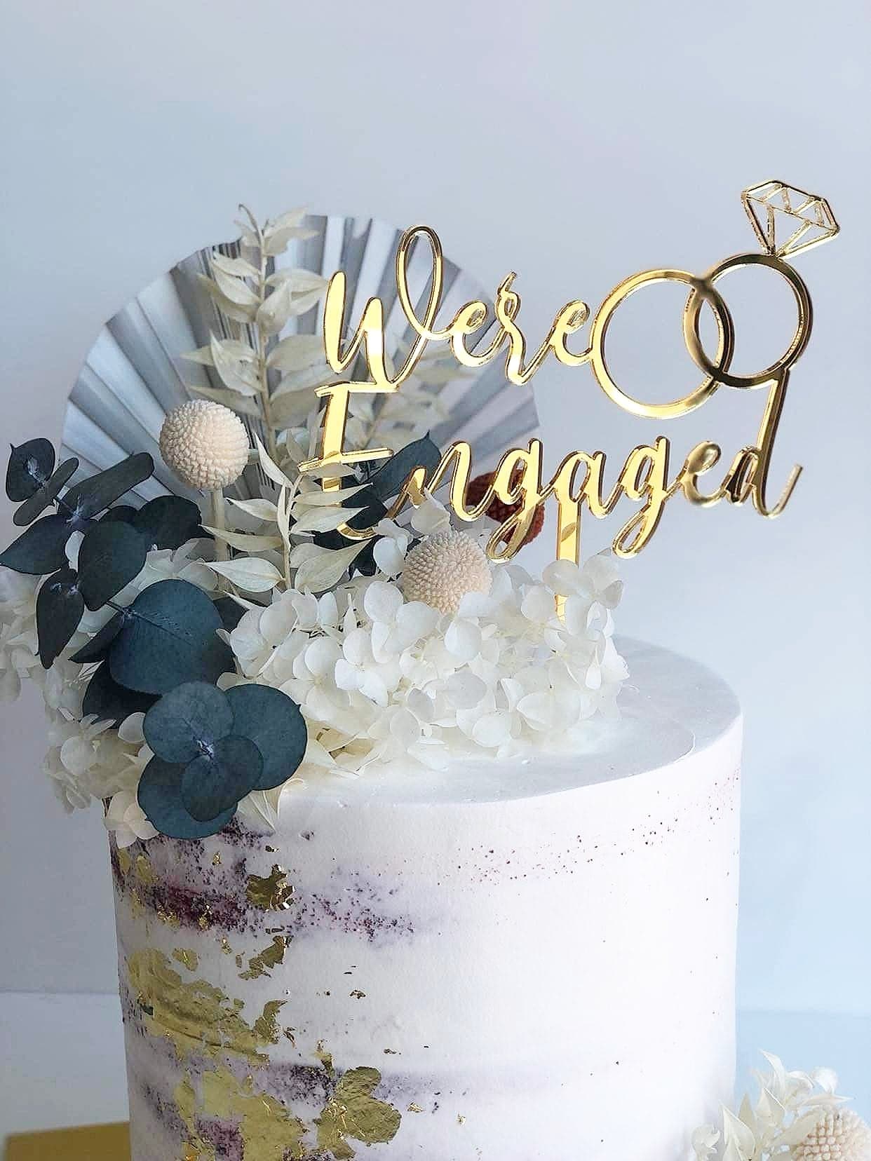 We're Engaged Cake Topper with rings